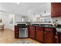 A modern kitchen featuring stainless steel appliances and dark countertops with matching cabinetry at 390 17Th Nw St # 1063, Atlanta, GA 30363