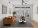 Bright living room with hardwood floors, neutral furniture, and a view to the outside patio at 390 17Th Nw St # 1063, Atlanta, GA 30363