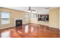 Spacious living room features a cozy fireplace, gleaming hardwood floors, and abundant natural light at 5027 Estonian Dr, Fairburn, GA 30213