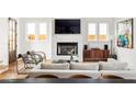 Bright living room with a modern fireplace, large TV, sleek chairs, and comfortable seating arrangement at 56 Walthall Ne St, Atlanta, GA 30307