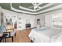 Spacious bedroom with hardwood floors, elegant trim, and ensuite bath access at 8160 Stone Hill Rd, Cumming, GA 30028