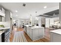 Bright, open kitchen with a center island, stainless steel appliances, and hardwood flooring at 8160 Stone Hill Rd, Cumming, GA 30028