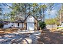 Charming single-Gathering home featuring stone accents, white siding, and a concrete driveway at 9377 Woodloop Ct, Jonesboro, GA 30238