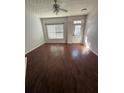Open-concept living room with modern wood-look flooring and ample natural light coming through the windows at 2372 Johnson Rd, Atlanta, GA 30345