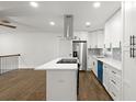 Sleek kitchen features stainless steel appliances and a modern island with barstool seating at 5539 Andrew Sw Dr, Mableton, GA 30126