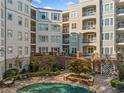 The courtyard of the condo features a covered pool, red brick, and multiple levels of condos with balconies and patios at 11 Perimeter E Ctr # 1115, Atlanta, GA 30346