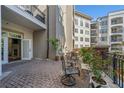 A charming brick patio with wrought iron seating and lush potted plants creates an inviting outdoor space at 11 Perimeter E Ctr # 1115, Atlanta, GA 30346