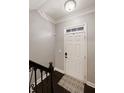 Bright entryway featuring a stylish rug, white door, and elegant crown molding at 3930 Covey Flush Sw Ct # 21, Smyrna, GA 30082