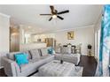 Spacious living area with a plush gray sectional, dark hardwood floors, and a view of the dining space at 5227 Whiteoak Se Ave, Smyrna, GA 30080