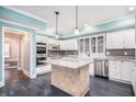 Bright kitchen featuring white cabinets, granite countertops, a kitchen island, and stainless steel appliances at 9610 Cedar Grove Rd, Fairburn, GA 30213