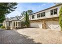 Large three-car garage with stone accents and circular brick driveway at 1666 Johnson Ne Rd, Atlanta, GA 30306