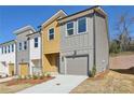 Newly built townhome showcases a modern exterior with a private garage and manicured front yard at 1696 Gunnin Nw Trce # 244, Atlanta, GA 30318