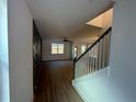 Inviting entryway with hardwood flooring, modern staircase, and natural light, creating a warm welcome at 4285 Easter Lily Ave, Buford, GA 30519