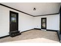 Covered carport featuring black trim, white ceiling, and a doorway to the home at 65 Sage St, Temple, GA 30179