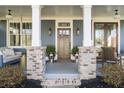 Inviting front porch with stylish seating and a charming craftsman-style door at 100 Daniel Se Ave, Atlanta, GA 30317