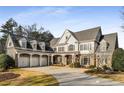 Charming two-story home features a three-car garage, covered front porch, and well-maintained landscaping at 12710 Old Surrey Pl, Roswell, GA 30075