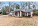 Charming single-story brick home with a well-manicured lawn and attached two-car garage at 1850 Cashmere Ct, Lithonia, GA 30058