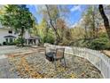 Charming backyard patio with a fire pit and seating area, perfect for outdoor relaxation at 7185 Peachtree Dunwoody Rd, Atlanta, GA 30328