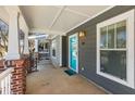 Covered front porch with brick columns and a vibrant blue door at 1126 Park Row South Se, Atlanta, GA 30312