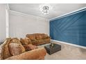 Comfortable living room with neutral carpet, modern lighting and accent wall at 1331 Ashbury Park Dr, Hoschton, GA 30548