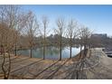 Scenic lake view surrounded by trees and a parking area under a clear sky at 1800 Clairmont Lk # A326, Decatur, GA 30033