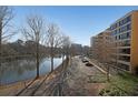 Lake view showing nearby building with balconies and parking in front under clear skies at 1800 Clairmont Lk # A326, Decatur, GA 30033