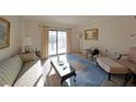 Cozy living room with sliding glass door to balcony, and traditional furnishings at 1800 Clairmont Lk # A326, Decatur, GA 30033