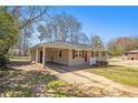 A cozy home with a covered carport and a well-manicured front yard at 1113 Grace Sw St, Mableton, GA 30126