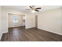 Open-concept living area with wood floors, connecting to a bright, renovated kitchen at 1113 Grace Sw St, Mableton, GA 30126