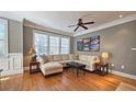 Comfortable living room with hardwood floors, large windows, and stylish furniture at 3699 Ashford Creek Ne Hl, Atlanta, GA 30319