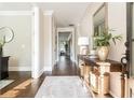 Elegant foyer featuring hardwood floors, a stylish console table, and a view into the home's interior at 3910 Cameron Ct, Cumming, GA 30040