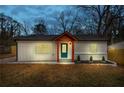 Charming single-story home featuring white siding, brick accents, and a vibrant blue front door at 926 Natham Dr, Atlanta, GA 30315