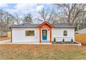 Charming single-story home featuring white siding, brick accents, and a vibrant blue front door at 926 Natham Dr, Atlanta, GA 30315