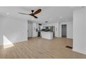 Spacious open-concept living area flowing into a modern kitchen, enhanced by hardwood floors and contemporary fixtures at 926 Natham Dr, Atlanta, GA 30315