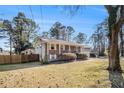 Charming brick home with a well-maintained lawn and fenced backyard, perfect for outdoor living at 959 Frontier Sw Trl, Marietta, GA 30060