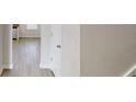 Bright hallway with light wood floors and white doors at 2357 Wellborn Hills Pl, Lithonia, GA 30058