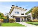 Stylish two-story home with an attached garage, modern siding, and a lush green lawn at 416 Glen Iris Ne Dr, Atlanta, GA 30308