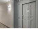 Apartment 61 is behind this gray door with stylish trim and modern lighting at 1101 Juniper St # 61, Atlanta, GA 30309