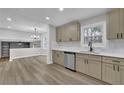 Modern kitchen with stainless steel dishwasher and views into living room at 2017 Allwood Ct, Lawrenceville, GA 30044