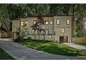 An inviting two-story home with modern black accents and a well-manicured lawn stands among mature trees at 2423 Melinda Ne Dr, Atlanta, GA 30345
