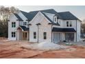 Beautifully crafted new home showcasing a painted brick facade, black roof and trim, plus an attached two-car garage at 3255 Hall Rd, Dacula, GA 30019