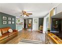 Bright living area featuring wood floors, stylish furniture, and an open layout to the kitchen at 4027 Finch Sw Rd, Powder Springs, GA 30127