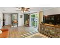 Comfortable living room with wood floors, a ceiling fan, sliding glass doors, and stylish decor at 4027 Finch Sw Rd, Powder Springs, GA 30127