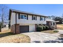 Classic two-story home with a brick and siding exterior, attached garage, and manicured landscaping at 5419 Golfcrest Cir, Stone Mountain, GA 30088