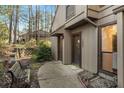 A unit entrance with an entrance walkway, bench, two doors, and brick landscaping at 1003 Cumberland Se Ct # 1003, Smyrna, GA 30080