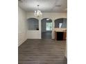 Open dining area with modern flooring, chandelier, and view to other rooms at 1530 Viero Dr, Lawrenceville, GA 30044