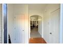 Inviting hallway with decorative archway and a mix of wood and wood-look floors at 1530 Viero Dr, Lawrenceville, GA 30044