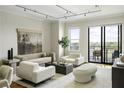 Bright living room featuring modern decor, neutral tones, and sliding glass doors to outdoor patio at 2233 Peachtree Ne Rd # 902, Atlanta, GA 30309