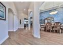 Dining room boasts hardwood floors, arched doorway, stylish light fixture and decorative accent wall at 329 Lakebridge Xing, Canton, GA 30114