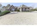 Gorgeous one-story home with brick exterior, circular driveway, and meticulously maintained landscaping at 329 Lakebridge Xing, Canton, GA 30114